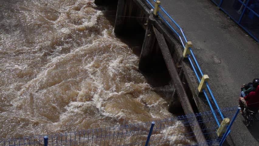 footage people cross through the bridge at the dam