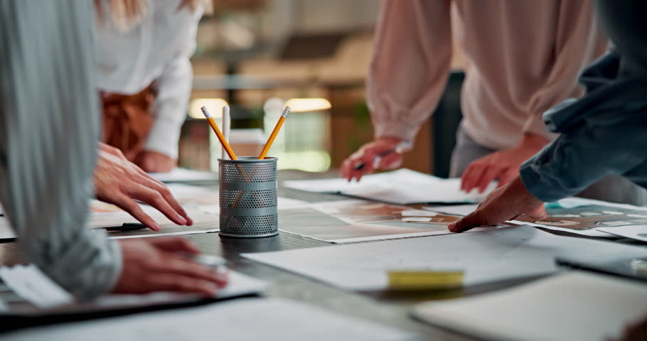 Meeting, desk and hands of business people for design, pattern and color for advertising agency. Creative company, teamwork and workers with documents for planning, collaboration and ideas in office