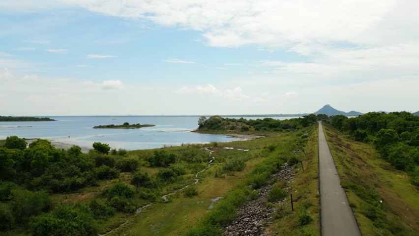 Drone aerial over Sri Lanka landscapes, rivers, local agriculture. Travelers, tourists, nature enthusiasts untouched scenery for discovery, relaxation. Adventurous routes for bikers, hikers.