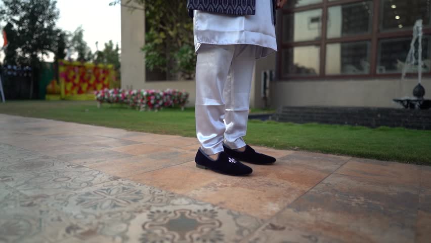 closeup of young men walking in traditional indian wear | walking feet  Royalty-Free Stock Footage #3495141751