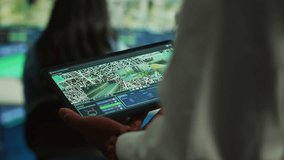 Manager tracking a delivery car by using satellite map for navigating around the city, monitoring orders via surveillance footage and CCTV system. Locating coordinates for shipping route. Camera A. - Powered by Shutterstock - Get 15% off with code: PIKWIZARD15