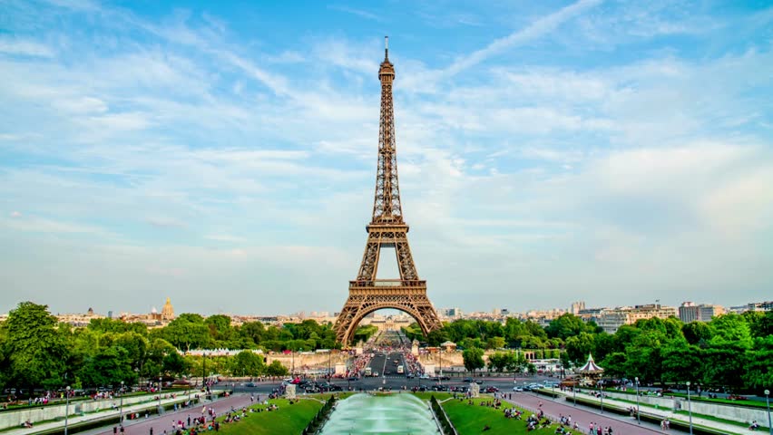 Views of the Eiffel Tower from Trocadero in Paris, France. Tourists enjoy historical landmark and symbol of Paris. Eiffel Tower With Gardens Of The Trocadero in a sunny summer day.