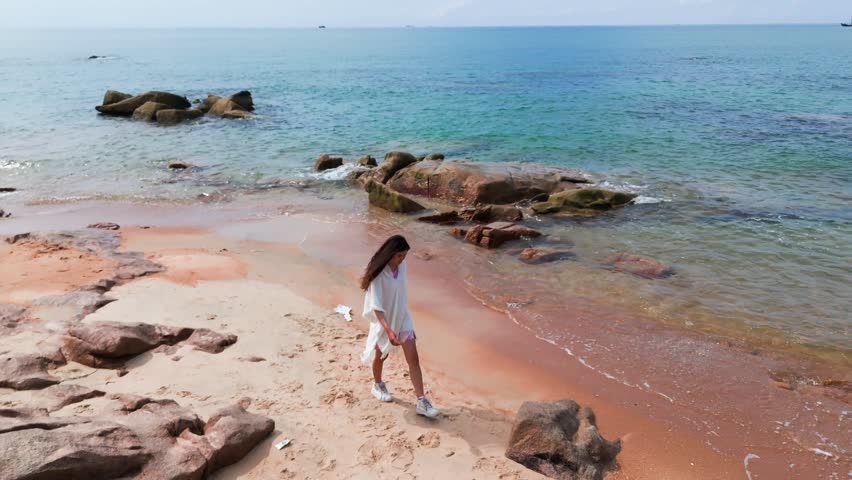 Areal view of a girl that is walking on the beach in Vietnam