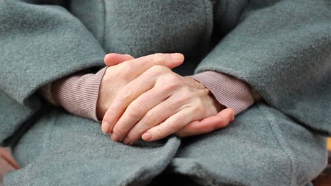 Close up of elderly woman hands, woman rubbing her hands shyly, feeling timidly