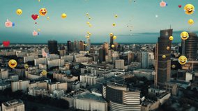 Animation of social media icons and emoji, likes, smileys, on aerial city background. Concept of online community, social media and communication. Digital connections and online networking. 4k footage - Powered by Shutterstock - Get 15% off with code: PIKWIZARD15