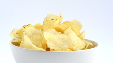 Hands taking potato chips from a bowl
