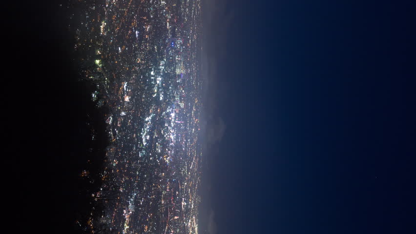 Vertical video - Night aerial timelapse of Sapporo city with low level clouds hovering above it