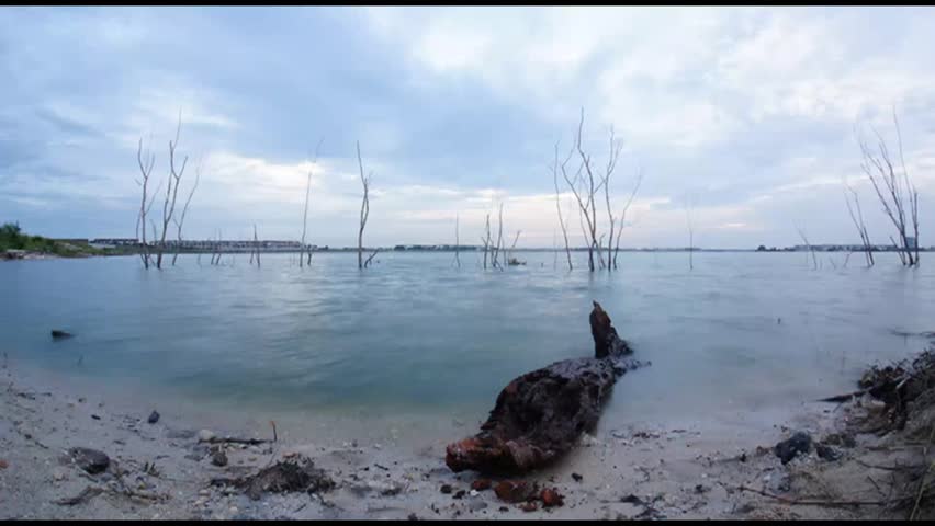 HD time lapse clip of sunset over the lake with cloudy