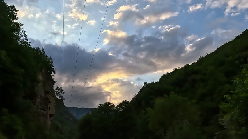 Road view on a summer day. Highways and landscape, palm trees and mountains, roadside and white road line markings.