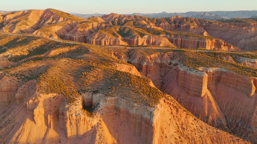 Scenic view of the Gorafe mountainous desert landscape in Andalusia, Spain. An aerial view of the rough, rocky Gorafe desert at sunrise. Drone footage of the amazing canyon with a country road