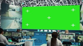 Courier agency operators monitoring cargo shipment with a greenscreen, working in observation room. Employees give directions to truck drivers stuck in traffic, CCTV system. Camera B. - Powered by Shutterstock - Get 15% off with code: PIKWIZARD15
