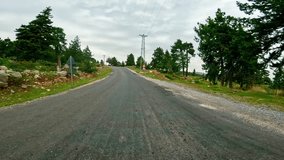 First-person video of driving, serpentine mountain road. Footage captures driving, serpentine path through scenic area. Experience driving, serpentine route in mountain terrain