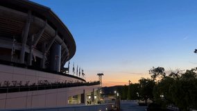 Stadium exterior at sunset, clear sky and flags fluttering, an urban modern architecture setting - Powered by Shutterstock - Get 15% off with code: PIKWIZARD15