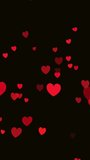 Vertical video clip screen saver of a smartphone, tablet for social networks with flying red hearts on a dark background.