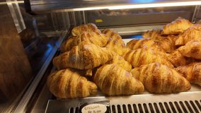 4k video footage of Various types of bread on display in a bakery or pastry such as macarons, croissants and danish. Modern bakery with different kinds of Loaf, bread, cakes and buns. - Powered by Shutterstock - Get 15% off with code: PIKWIZARD15