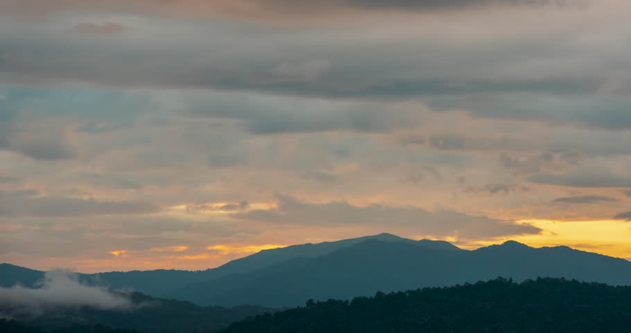 Timelapse Sunset mountain range beautiful landscape mist, dusk golden time dramatic sky. Time lapse Beautiful landscape motion high mountain ridge mist panning panorama scenery dawn dramatic sky. 