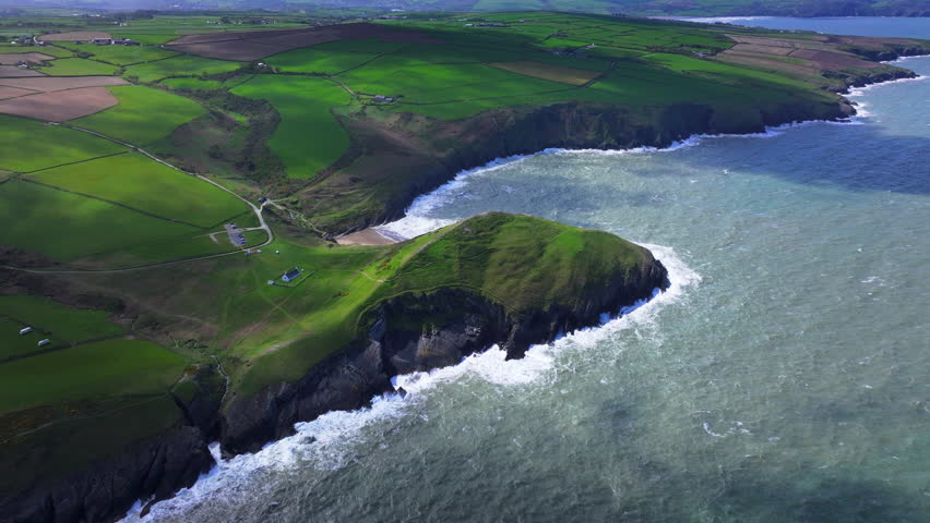Aerial shot of Welsh coastline and Mwnt promonontry with beach