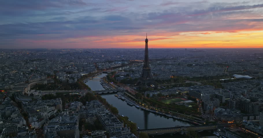 Beautiful view of famous Eiffel Tower in France with colorful twilight romantic sky. Wide establishing aerial morning sunrise or sunset of paris city center best travel destinations landmark in Europe