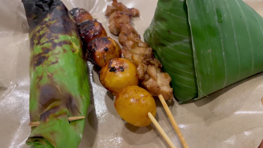 Nasi angkringan or nasi kucing traditional food from central java Indonesia. Nasi kucing with egg satay and chicken skin