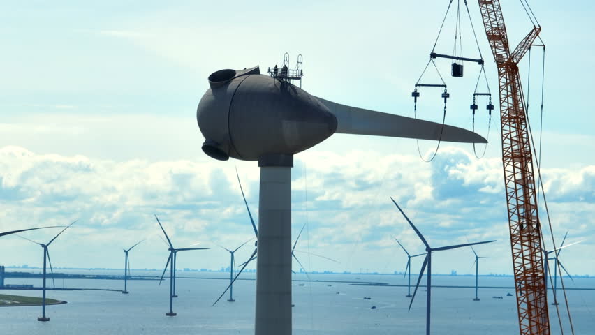 Wind turbine construction works with rows of wind turbines in an offshore windpark in The Netherlands.