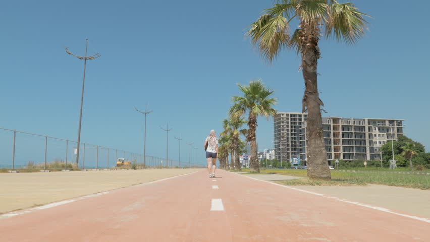 Young woman walks on the street. Batumi, Georgia