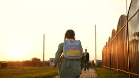 child runs into arms happy father. happy schoolboy spins his father arms. dream flying. girl runs through park with school backpack. father hugs child sunset. happy parent. Family man with kid girl. - Powered by Shutterstock - Get 15% off with code: PIKWIZARD15