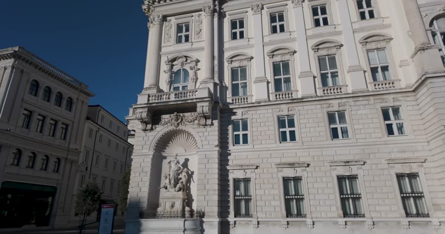 A pan shot of Palazzo del Lloyd Triestino in Trieste Piazza Grande Italy in the  morning revealing the facade front in 4K