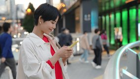 Young Asian woman using a smart phone in modern city. - Powered by Shutterstock - Get 15% off with code: PIKWIZARD15