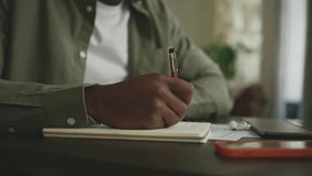 Close up of man's hand writing with pen in notebook - Powered by Shutterstock - Get 15% off with code: PIKWIZARD15