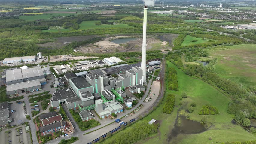 The Asdonkshof waste incineration plant in Kamp Lintfort. Thermal waste treatment and recycling. Combustion of waste, converted into new energy. Industrial installation. Aerial drone view. Royalty-Free Stock Footage #3496240499