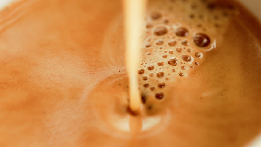 Espresso pouring to cup from coffee maker machine. High quality footage