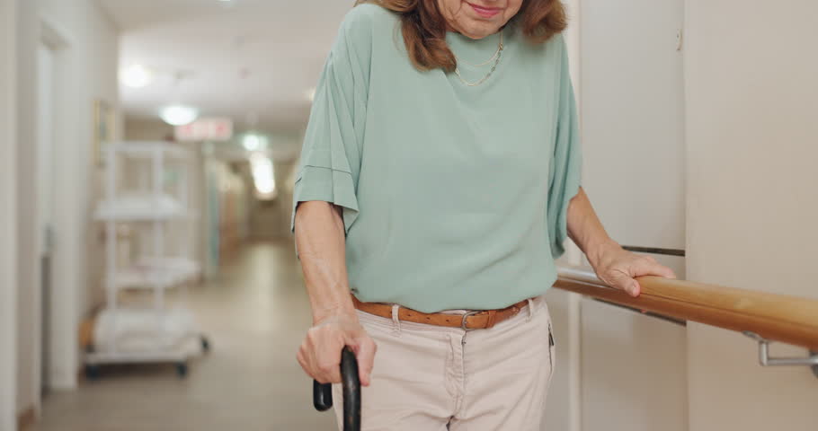 Hands, hospital or walking stick and person with disability in corridor for recovery or rehabilitation. Balance, stability or support and patient in health clinic with cane for assistance or help