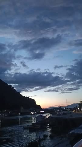 Beautiful views of mountains and clouds accompanied by ships at nightfall