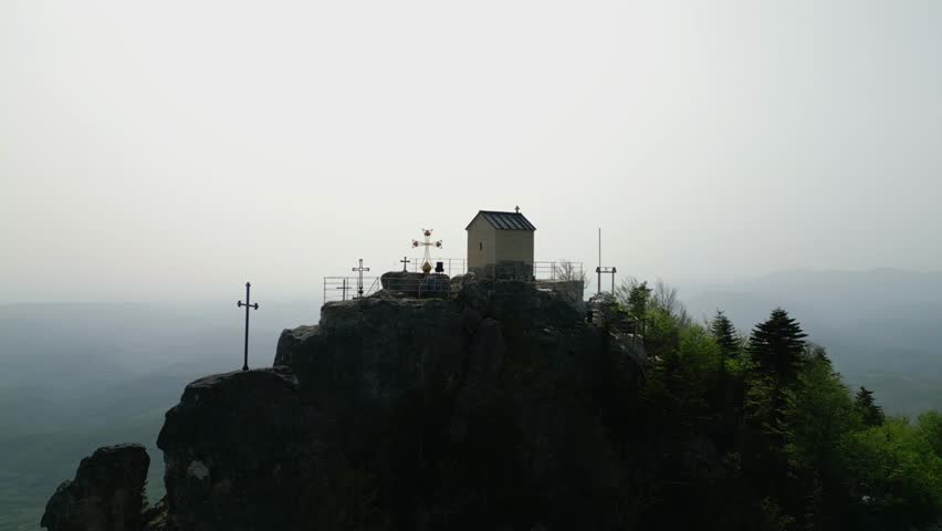 small church on top of a mountain,overlooking the valley,aerial view,medium shot