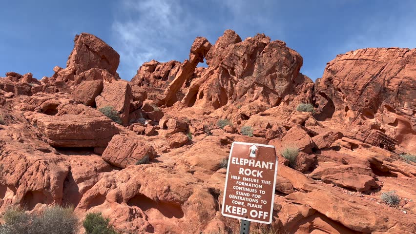 Famous Elephant Rock and surrounding red sandstone formations with information sign in the foreground - Valley of Fire State Park, Nevada, USA