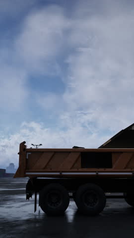 A large dump truck is parked in front of a building, creating a scene of construction or transportation activities.