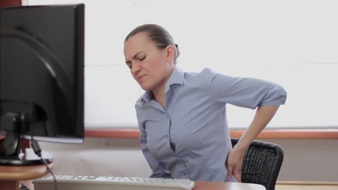 Young business woman with back pain