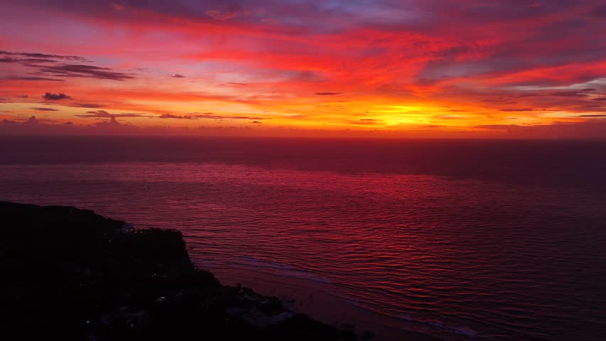 Aerial shot of sunset in Uluwatu beach. Uluwatu beach has the best sunsets in Bali.	