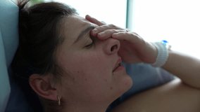Close-up face of pregnant woman experiencing pain during pre labor contractions hand on forehead with eyes closed and taking deep breaths, side profile - Powered by Shutterstock - Get 15% off with code: PIKWIZARD15