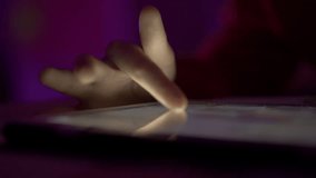 Girl Browsing Digital Tablet Computer With Finger at Night. Person Using Smartphone, Browsing on Social Network. Close-up Finger Scrolling Social Media App Feed or Reading News Feed Online.  - Powered by Shutterstock - Get 15% off with code: PIKWIZARD15