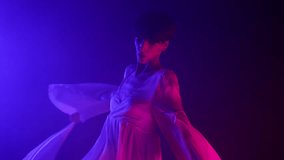 Feminine woman in silk dress dancing modern choreography - contemporary style dance in neon studio. - Powered by Shutterstock - Get 15% off with code: PIKWIZARD15