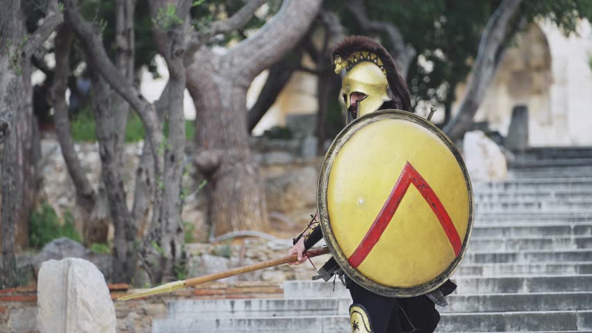 Spartan hoplite warrior going forward in attack with sword