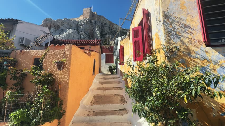 Anafiotika historic neighborhood with colorful houses and narrow streets under the Acropolis, Athens, Greece on sunny summer day