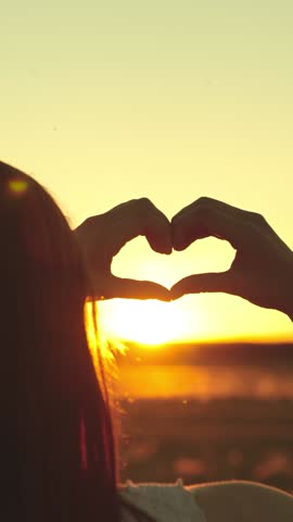 girl shows hand sign heart gesture sunset, feminine woman love travel happy family, hopeful romantic dream, girl expressing hope, sunset harmony concept, summer love gesture, heart hands sky, girl