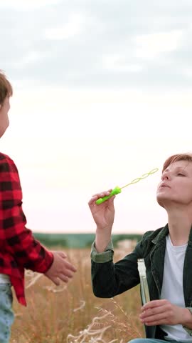 Mother child kid Son Soap Bubbles, happy family, passion game, wind barely noticeable, everything possible, world childhood, air fresh, joy faces, playing together, bubble burst, jeans are comfortable