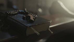Prayer rosary beads and Holy Bible Christian symbols close up. Sacred book and religious prayer necklace with cross on wooden desk in church closeup - Powered by Shutterstock - Get 15% off with code: PIKWIZARD15
