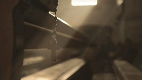 Rosary with wooden cross hanging from Holy Book and swinging close up. Christian prayer beads and psalmbook closeup. Religious symbols background - Powered by Shutterstock - Get 15% off with code: PIKWIZARD15