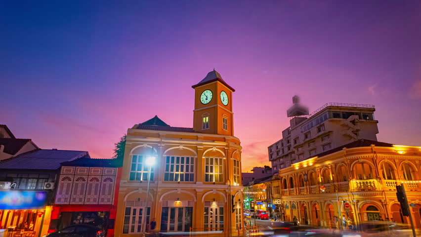 Time lapse Tourists admire the clock tower, a beautiful old building at Charter Intersection in the heart of Phuket Town.
clock tower the ancient building and popular landmark in Phuket city