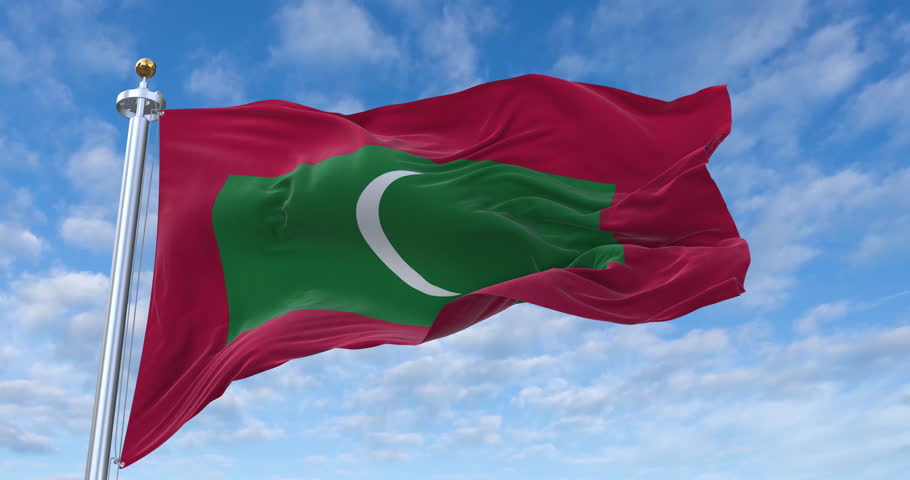 Maldives flag with flagpole waving in wind, rolling clouds background looping, 4K video (Perfect Loop)