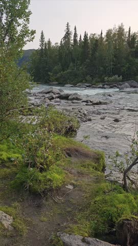 The Gamajåhkå river with wild rapids in the Swedish town of Kvikkjokk on a cold August evening in early autumn at the halfway point of the Kungsleden long-distance hiking trail